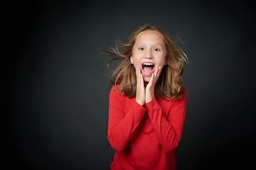 Image showing Excited surprised preteen girl screaming of joy