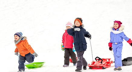 Image showing happy little kids with sleds in winter