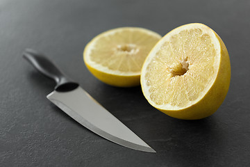 Image showing close up of chopped lemon and knife on table