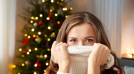 Image showing young woman or teen girl pulling pullover collar