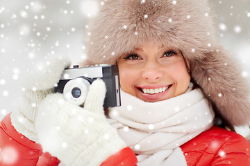 Image showing happy woman with film camera outdoors in winter