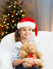 Image showing smiling little girl with teddy bear on christmas