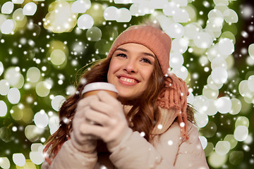 Image showing happy woman with coffee over christmas lights