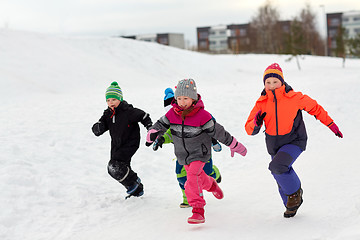 Image showing happy little kids running outdoors in winter