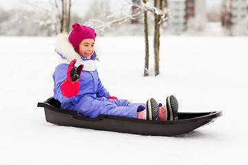 Image showing happy little girl on sled outdoors in winter