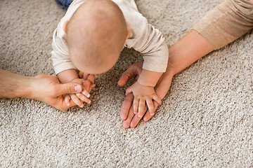 Image showing close up of family with baby on carpet