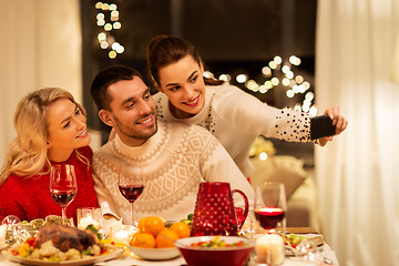 Image showing friends taking selfie at christmas dinner