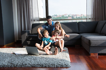 Image showing Family Playing Together with laptop computer