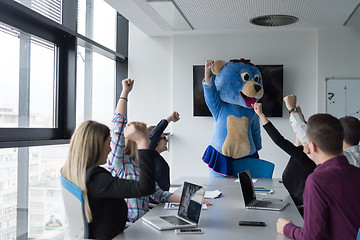 Image showing boss dresed as bear having fun with business people in trendy of