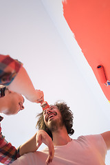 Image showing couple painting interior wall