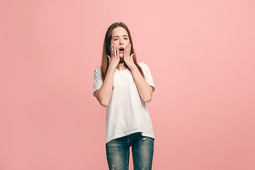 Image showing Beautiful teen girl looking suprised isolated on pink