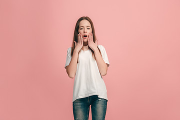 Image showing Beautiful teen girl looking suprised isolated on pink