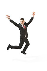 Image showing Above front portrait of a businessman with very serious face. Confident professional jumping in the foreground of the camera.