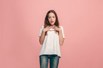 Image showing Beautiful teen girl looking suprised isolated on pink