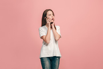 Image showing The happy teen girl standing and smiling against pink background.