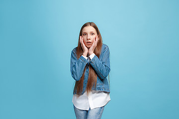 Image showing Beautiful teen girl looking suprised isolated on blue