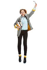 Image showing Full length portrait of a happy surprised female student holding books isolated on white background