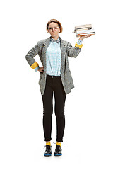 Image showing Full length portrait of a happy smiling female student holding books isolated on white background