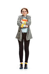 Image showing Full length portrait of a happy smiling female student holding books isolated on white background