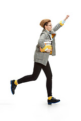 Image showing Full length portrait of a happy smiling female student holding books isolated on white background