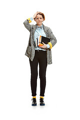 Image showing Full length portrait of a sad female student holding books isolated on white background