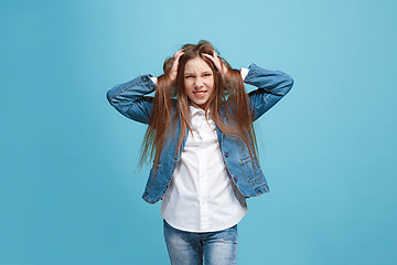 Image showing The squint eyed teen girl with weird expression isolated on blue