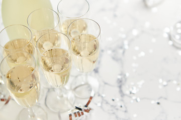 Image showing Champagne glasses and bottle placed on white marble background