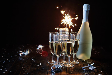 Image showing Party composition image. Glasses filled with champagne placed on black table