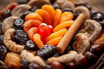 Image showing Mix of dried fruits in a small wicker basket on wooden table