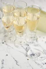 Image showing Champagne glasses and bottle placed on white marble background