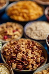 Image showing Assortment of different kinds cereals placed in ceramic bowls on table