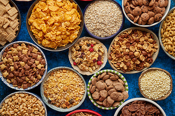 Image showing Assortment of different kinds cereals placed in ceramic bowls on table