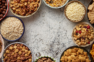 Image showing Assortment of different kinds cereals placed in ceramic bowls on table