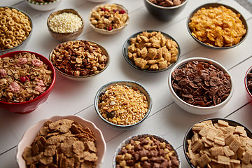 Image showing Assortment of different kinds cereals placed in ceramic bowls on table