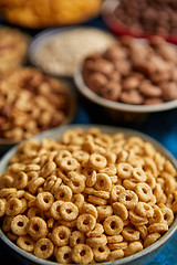 Image showing Assortment of different kinds cereals placed in ceramic bowls on table