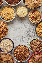 Image showing Assortment of different kinds cereals placed in ceramic bowls on table