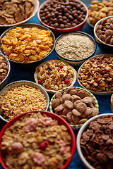 Image showing Assortment of different kinds cereals placed in ceramic bowls on table