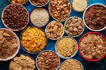 Image showing Assortment of different kinds cereals placed in ceramic bowls on table