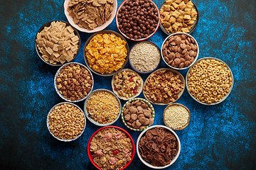 Image showing Assortment of different kinds cereals placed in ceramic bowls on