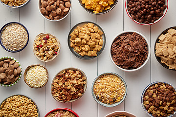 Image showing Assortment of different kinds cereals placed in ceramic bowls on table