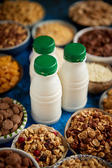 Image showing Assortment of different kinds cereals placed in ceramic bowls on table