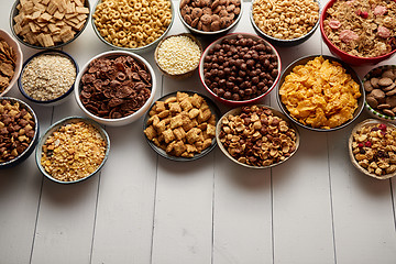 Image showing Assortment of different kinds cereals placed in ceramic bowls on table