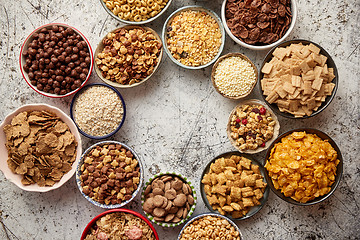 Image showing Assortment of different kinds cereals placed in ceramic bowls on table