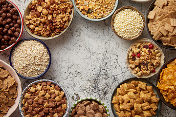 Image showing Assortment of different kinds cereals placed in ceramic bowls on table