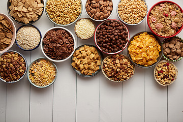 Image showing Assortment of different kinds cereals placed in ceramic bowls on table