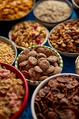 Image showing Assortment of different kinds cereals placed in ceramic bowls on table