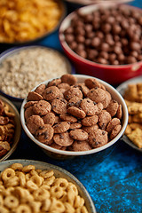 Image showing Assortment of different kinds cereals placed in ceramic bowls on table