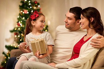 Image showing happy family with christmas present at home