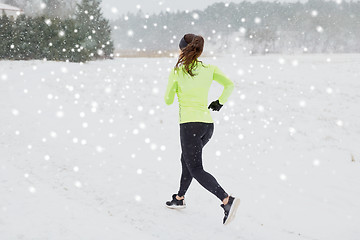 Image showing woman running outdoors in winter