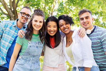 Image showing happy international friends hugging in park